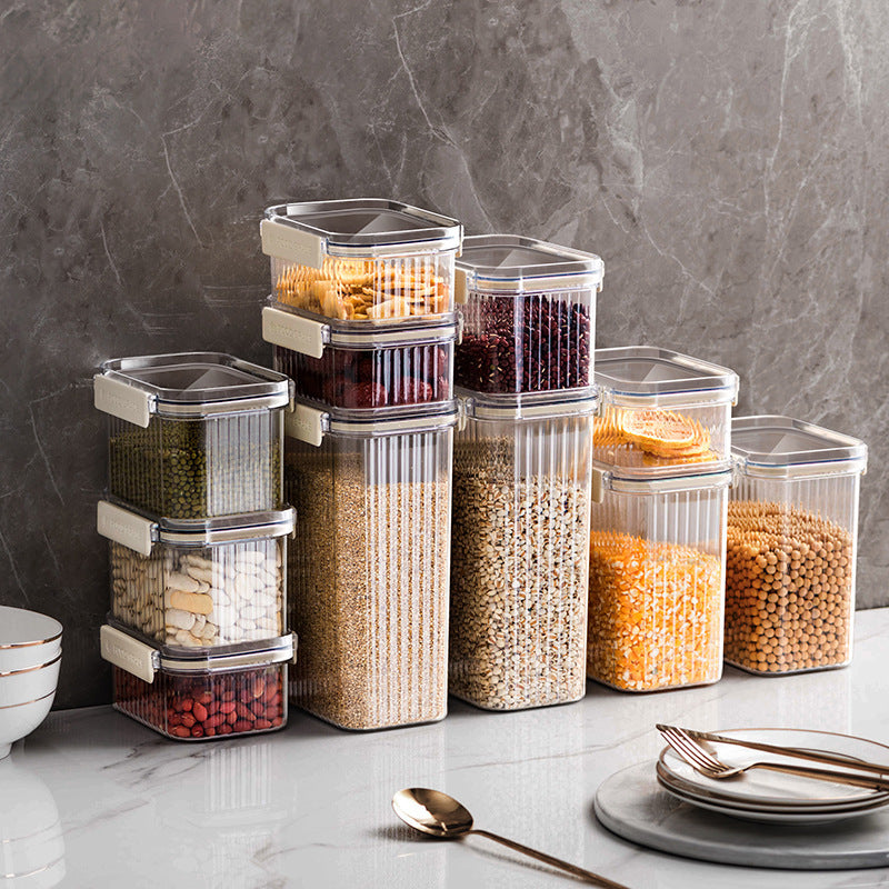 Set of clear food storage containers with different foods on a kitchen counter.
