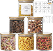 Set of glass jars with various dry goods and labels on a white background