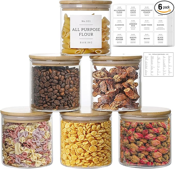 Set of glass jars with various dry goods and labels on a white background