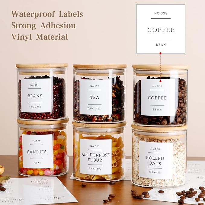 Jars with labels on a table with various food items inside, featuring waterproof labels and strong adhesion.