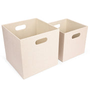 Two beige storage cubes with handles on a white background