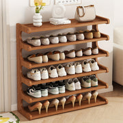 Wooden shoe rack with various shoes on a wooden floor.