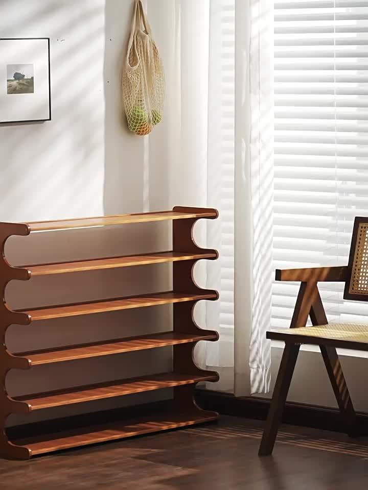 Wooden shelf against a wall with a chair and bag in the background