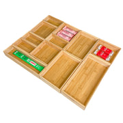 Wooden compartmentalized tray with compartments containing small packets on a white background