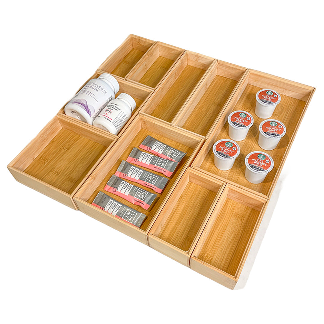Wooden organizer with compartments containing various items on a white background