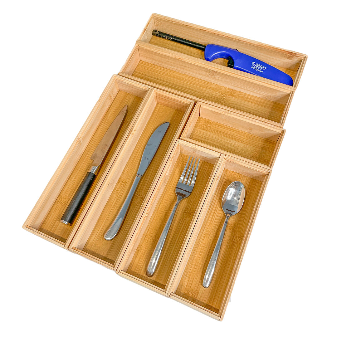 Wooden cutlery organizer with knives, fork, and spoon on a white background
