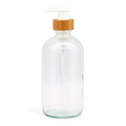 Clear glass bottle with a wooden cap on a white background