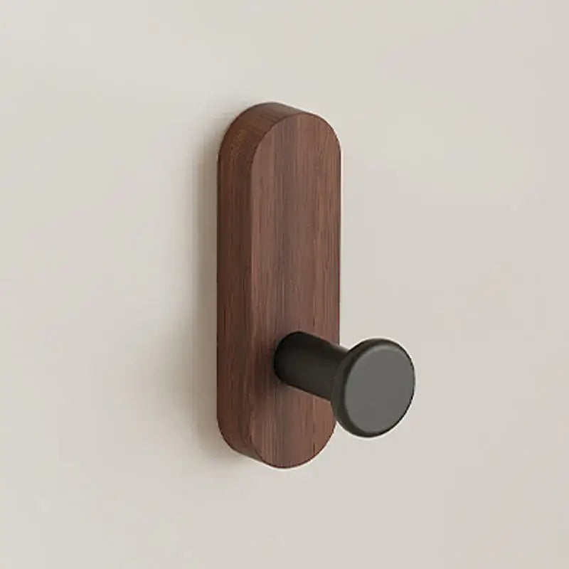 Wooden door handle with black finish on a beige background