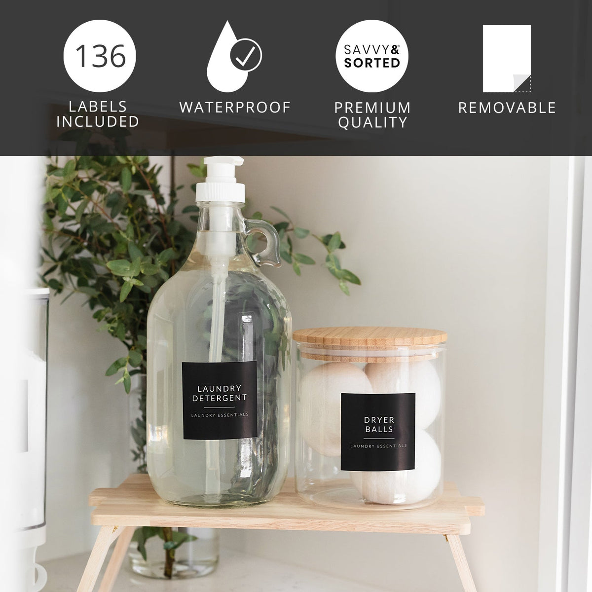 Laundry detergent bottle and dryer balls with labels on a wooden stand.