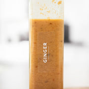 Ginger-flavored smoothie in a glass with a white background